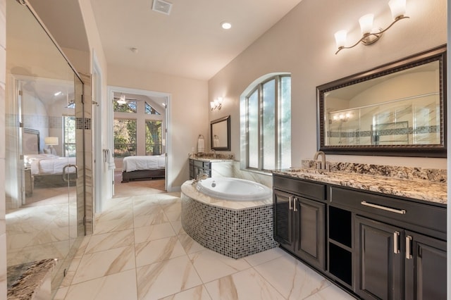 bathroom with vanity, vaulted ceiling, and shower with separate bathtub