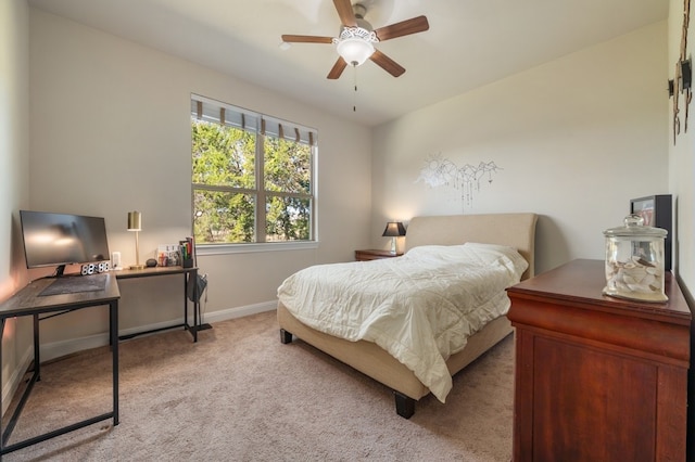 bedroom with ceiling fan and light carpet