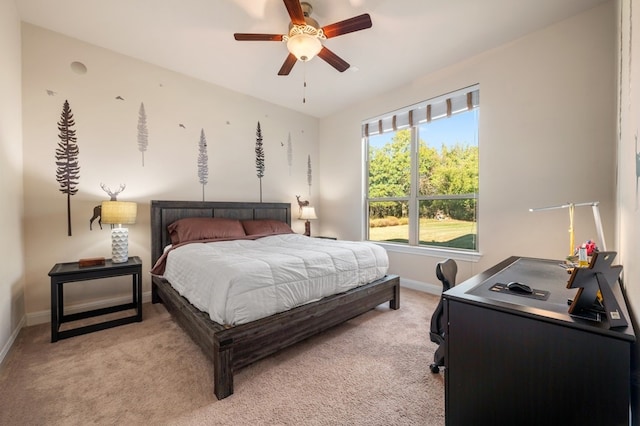 bedroom with ceiling fan and light carpet