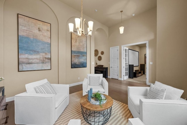 465 Linden Loop, Driftwood, TX 78619 - living area featuring light wood-type flooring, a chandelier, baseboards, and arched walkways