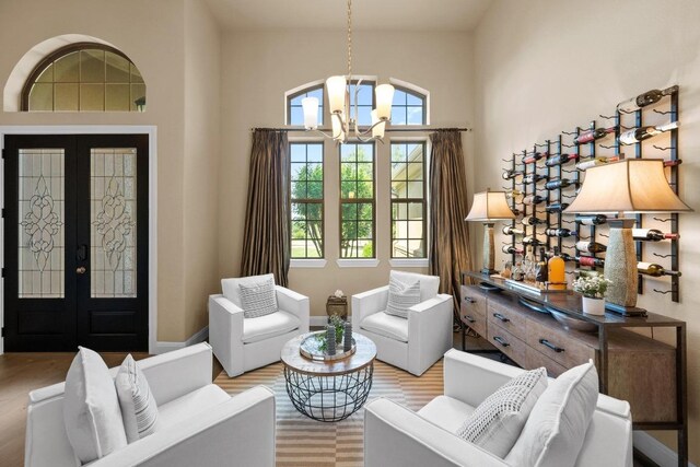 465 Linden Loop, Driftwood, TX 78619 - sitting room featuring a chandelier, french doors, wood finished floors, and high vaulted ceiling