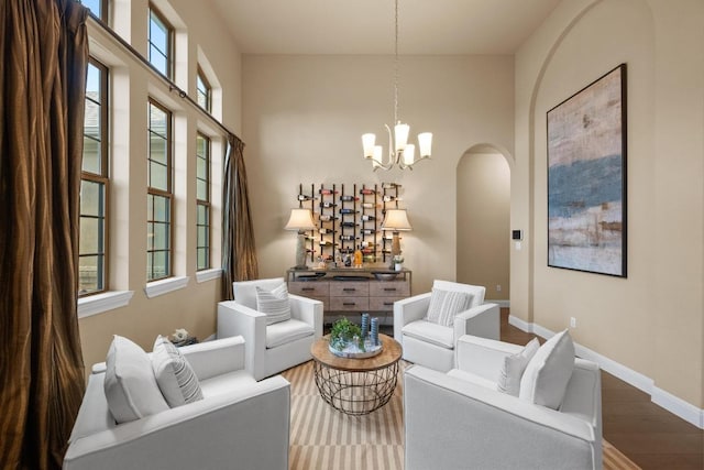 465 Linden Loop, Driftwood, TX 78619 - living area featuring arched walkways, wood finished floors, and healthy amount of natural light