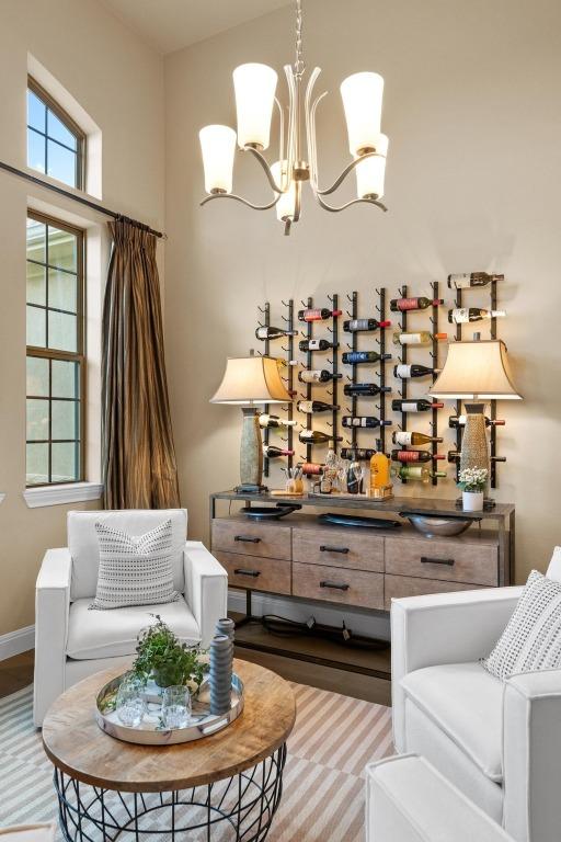465 Linden Loop, Driftwood, TX 78619 - living area with a chandelier, wood finished floors, and baseboards
