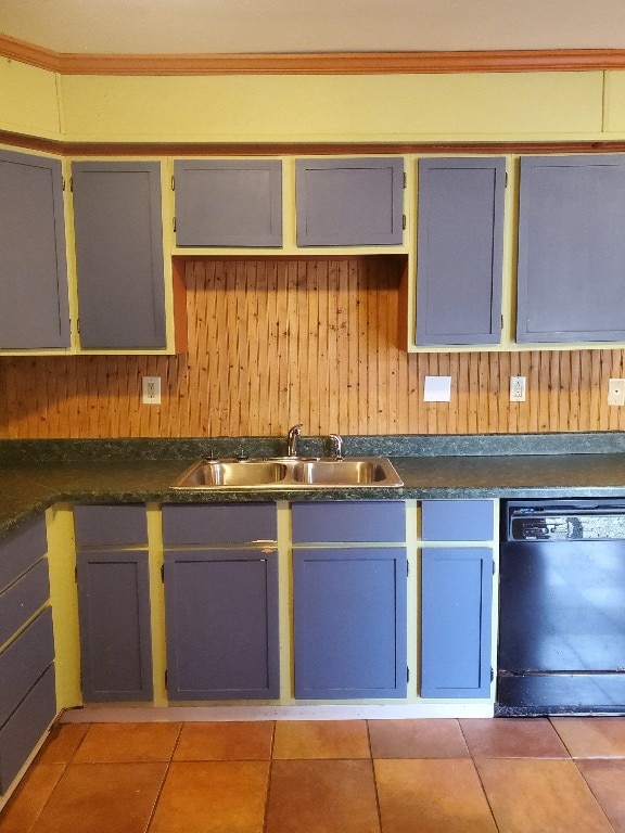 kitchen with wood walls, sink, light tile patterned floors, and black dishwasher