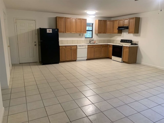 kitchen featuring white appliances, sink, and light tile patterned floors