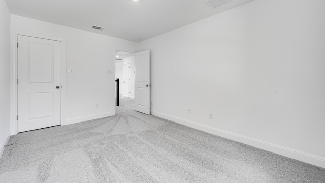unfurnished bedroom featuring baseboards and light colored carpet