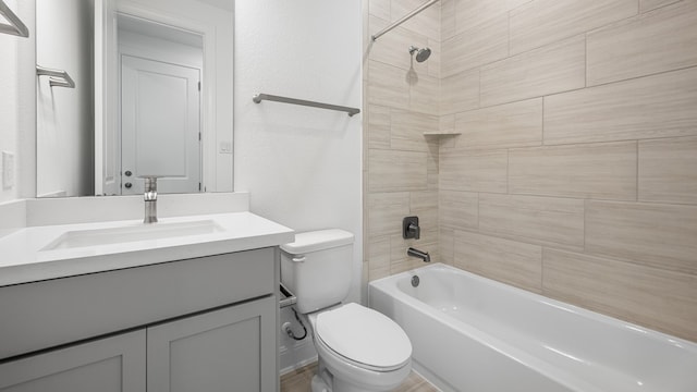 full bathroom with toilet, vanity, and shower / tub combination