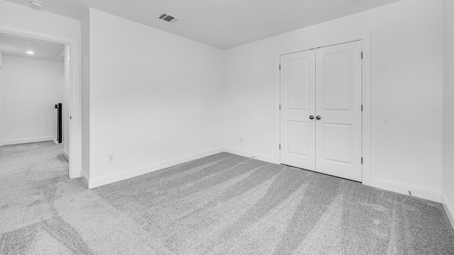 carpeted empty room with baseboards