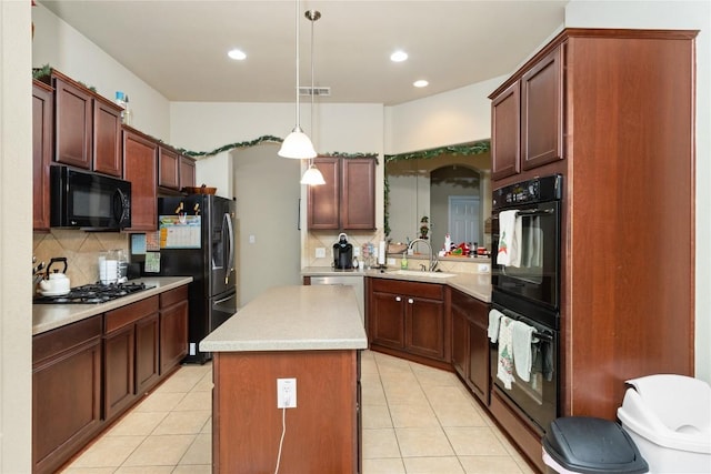 kitchen with backsplash, sink, black appliances, pendant lighting, and a kitchen island