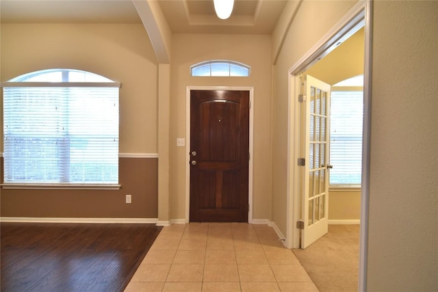 foyer with light hardwood / wood-style flooring and a healthy amount of sunlight