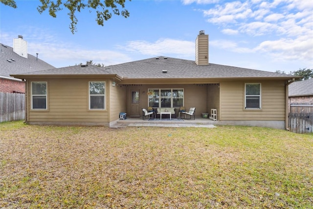 back of house featuring a yard and a patio