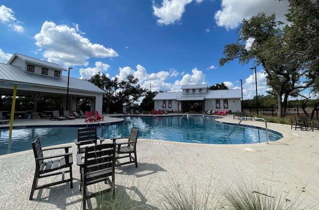 view of swimming pool featuring a patio area