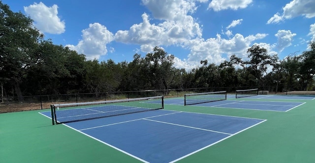 view of tennis court featuring basketball hoop