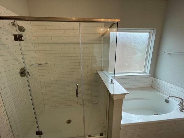 bathroom with separate shower and tub