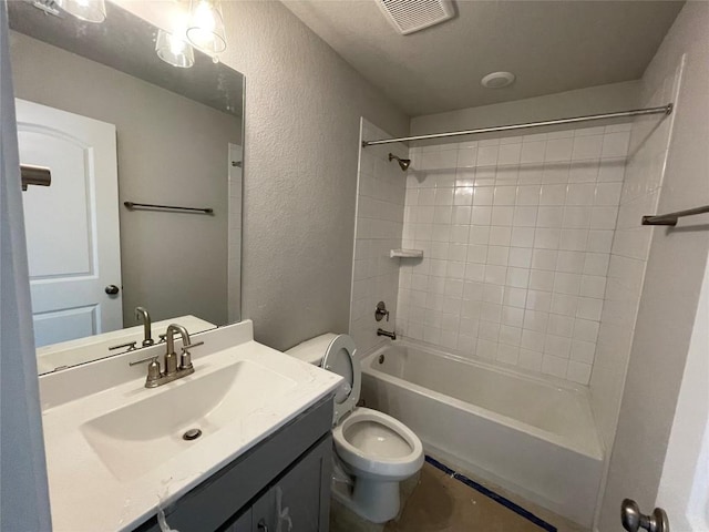 full bathroom featuring tiled shower / bath combo, vanity, and toilet