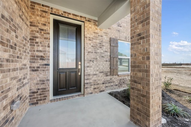 entrance to property with brick siding