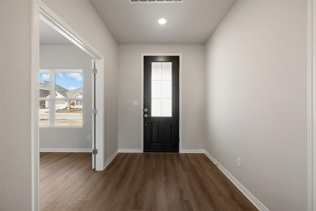 entrance foyer with dark wood-style flooring, visible vents, and baseboards