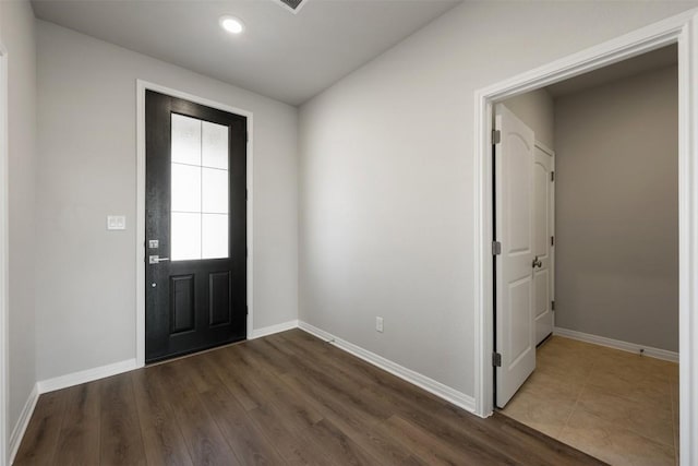 entryway featuring baseboards and dark wood finished floors