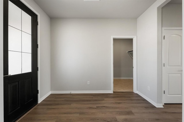 foyer featuring dark wood-style floors and baseboards