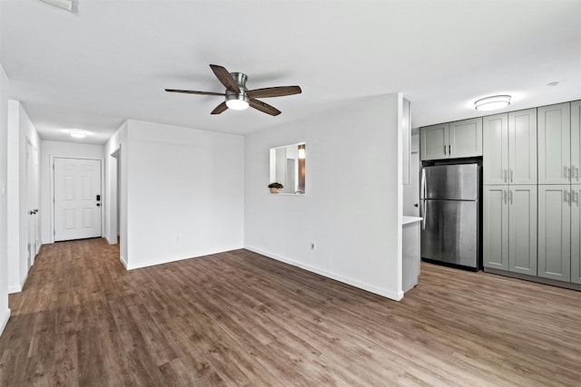 unfurnished living room featuring ceiling fan and hardwood / wood-style floors