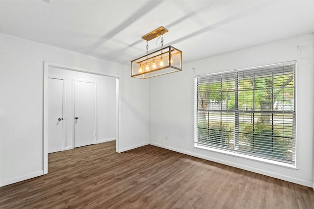 interior space with dark hardwood / wood-style floors and a chandelier