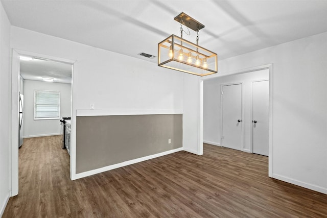 unfurnished dining area featuring dark hardwood / wood-style floors