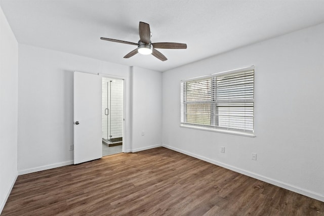 unfurnished bedroom featuring ensuite bathroom, ceiling fan, and dark hardwood / wood-style flooring