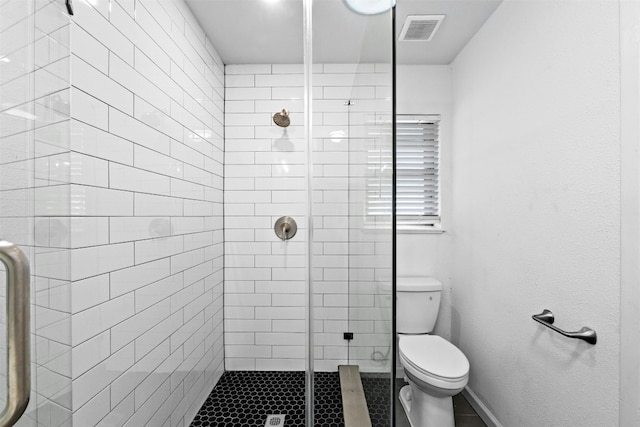 bathroom with walk in shower and toilet