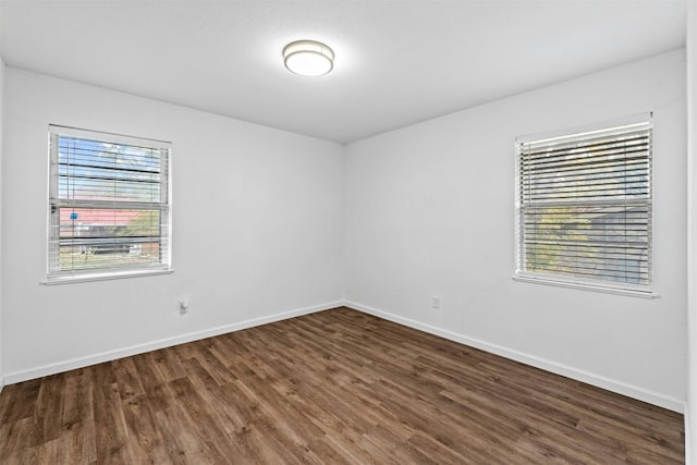 empty room featuring dark wood-type flooring