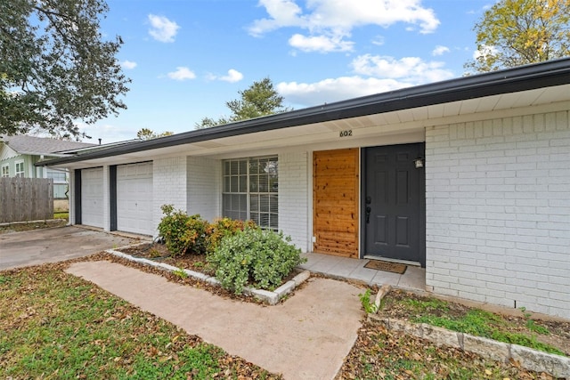 doorway to property featuring a garage and covered porch