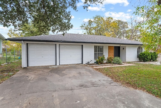 ranch-style house featuring a garage and a front yard