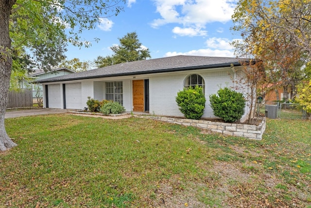 ranch-style home featuring a garage, central AC unit, and a front lawn