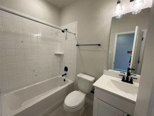 full bathroom featuring toilet, vanity, and tiled shower / bath