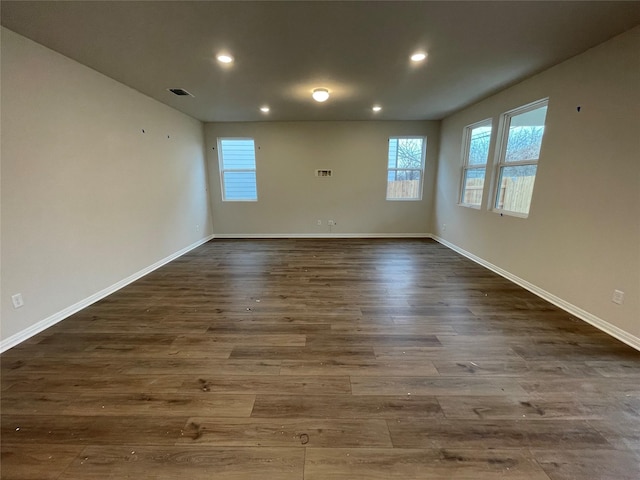 unfurnished room with dark hardwood / wood-style floors