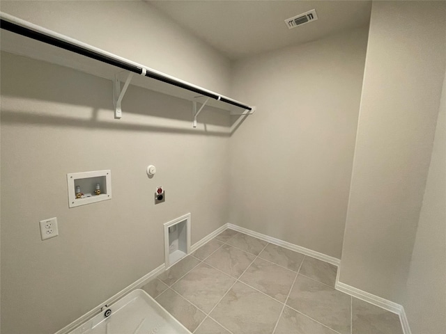 clothes washing area featuring washer hookup, light tile patterned floors, gas dryer hookup, and hookup for an electric dryer