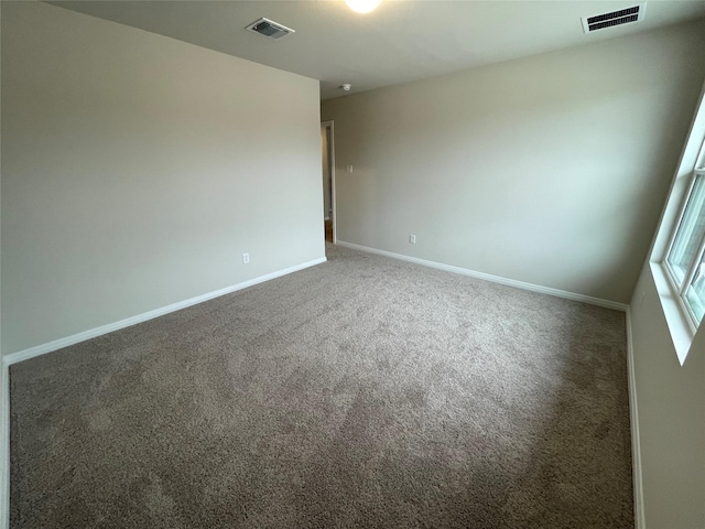 unfurnished room with dark carpet