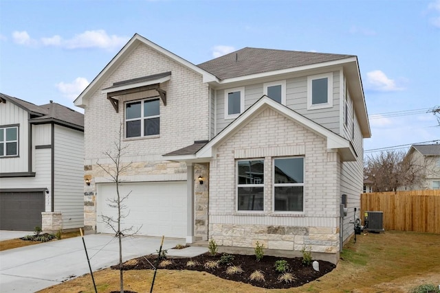 view of front of home with a garage, central AC unit, and a front yard