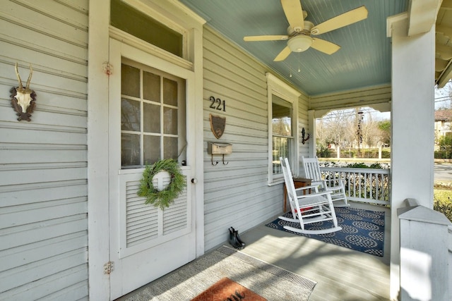 deck featuring a porch and a ceiling fan