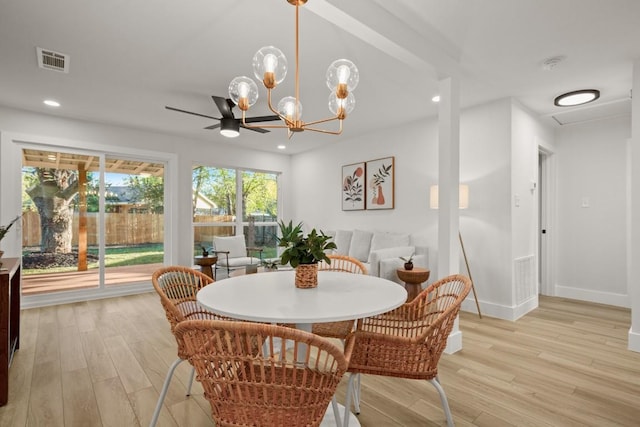 dining area featuring light wood-type flooring and a notable chandelier