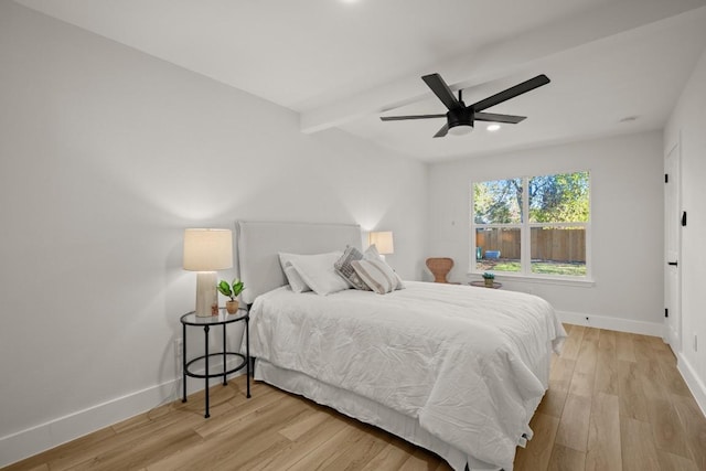 bedroom featuring vaulted ceiling with beams, ceiling fan, and light wood-type flooring