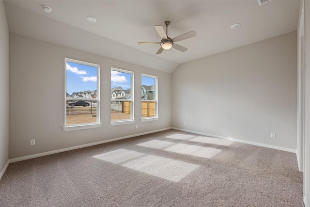 unfurnished room featuring vaulted ceiling, light carpet, and ceiling fan