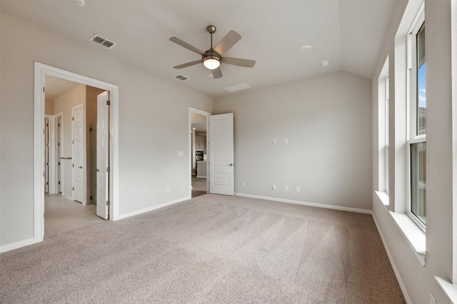 unfurnished bedroom featuring ceiling fan, vaulted ceiling, and light carpet