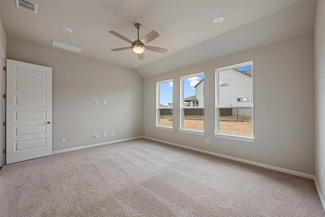 carpeted spare room featuring lofted ceiling and ceiling fan