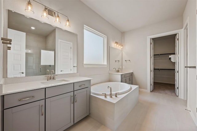 bathroom with shower with separate bathtub, tile patterned floors, and vanity