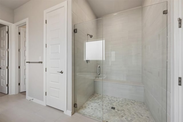 bathroom featuring a shower with door and tile patterned flooring