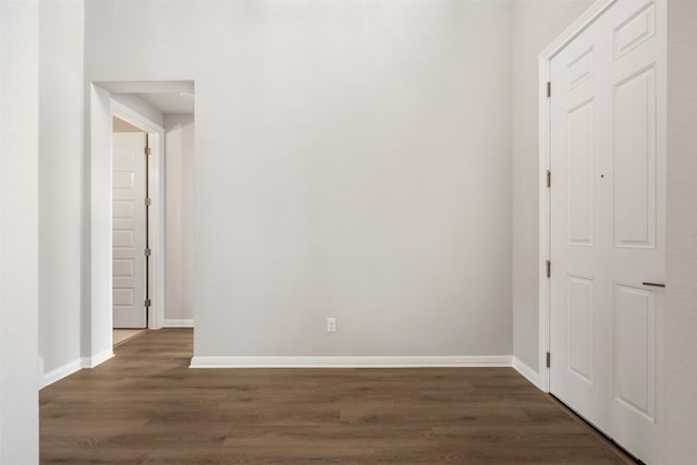 hallway with dark hardwood / wood-style floors