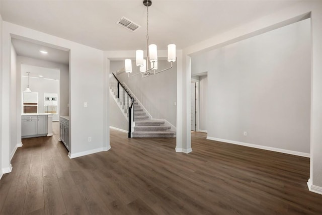 interior space with dark wood-type flooring and a notable chandelier