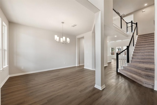 interior space featuring dark hardwood / wood-style flooring and an inviting chandelier