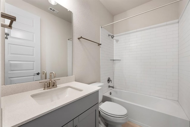 full bathroom with vanity, toilet, and tiled shower / bath combo