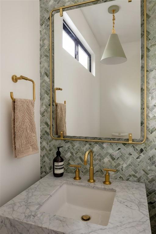 bathroom featuring tasteful backsplash and vanity